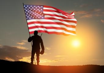 An image of a Navy veteran standing in front of the American flag.