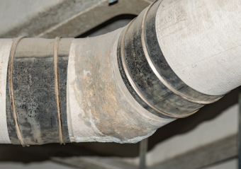 An asbestos pipe used for a gas line in a building